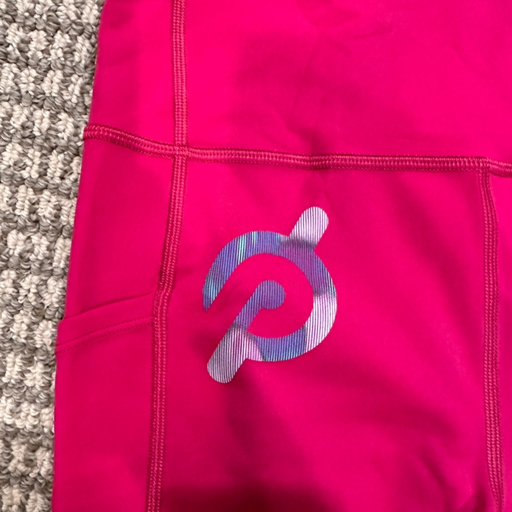 NWOT size medium Peloton Interactive pink leggings. Side and key pocket.